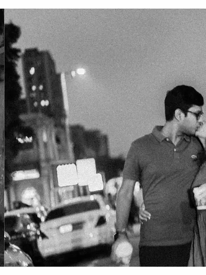 A black and white collage showing a kiss amidst city lights, capturing the classic romance of a night in the city.