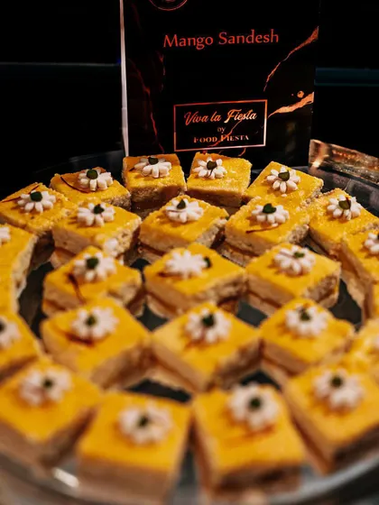 Keep calm and eat Sandesh. This tray of delicate Mango Sandesh, a classic Bengali sweet, is garnished with tiny flowers, making it as beautiful as it is delicious.
