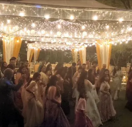A wide shot of the elegant outdoor wedding party.