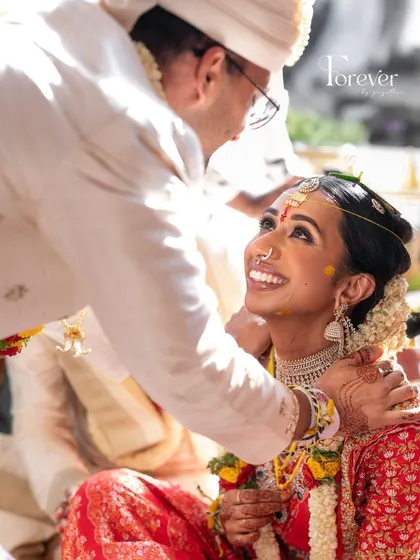 The pure joy on a bride's face during the wedding rituals. Her makeup is fresh and natural, designed to enhance her happiness, not mask it.
