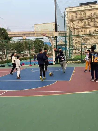 A player dribbles the ball while being guarded.