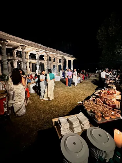 A wide shot of the buffet and dining area at the Hampi wedding, showcasing the scale of the event and the beautiful setting.