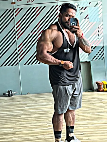 A side bicep pose in the mirror.
