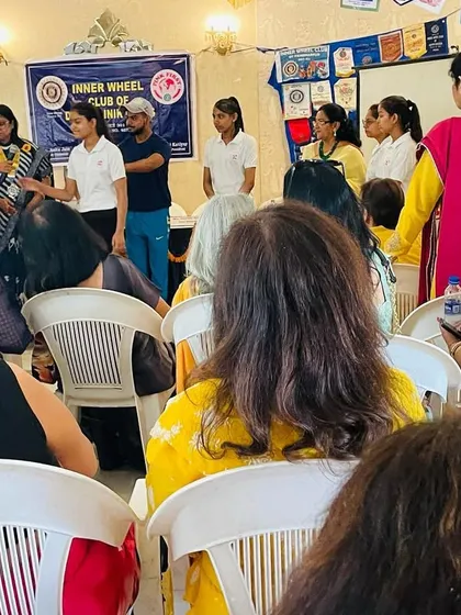 A student demonstrates a technique for the audience at the Inner Wheel Club workshop. Live demos help people understand how simple and effective these moves can be.