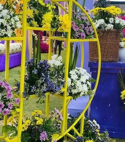 A unique circular yellow shelf used for displaying floral arrangements. This is one of the small details we use to make our decor stand out.