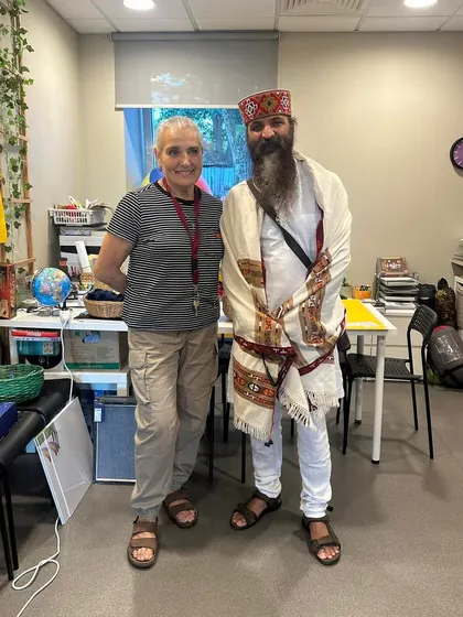 With a student in her classroom. It's a reminder that you can change your habits, and your habits will change your future. This is the essence of Karma Yoga.