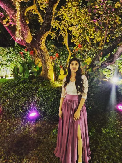 A full-length view of the mauve slit skirt and white lace top. This Indo-Western outfit is perfect for an evening event where you want something elegant but not strictly traditional.