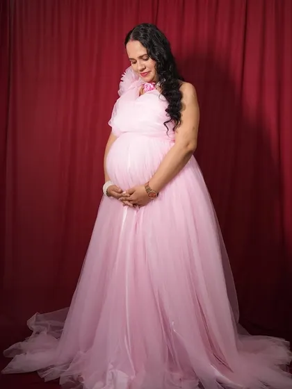 A full-length view of the pink tulle maternity gown. It’s light, comfortable, and perfect for capturing your baby bump.