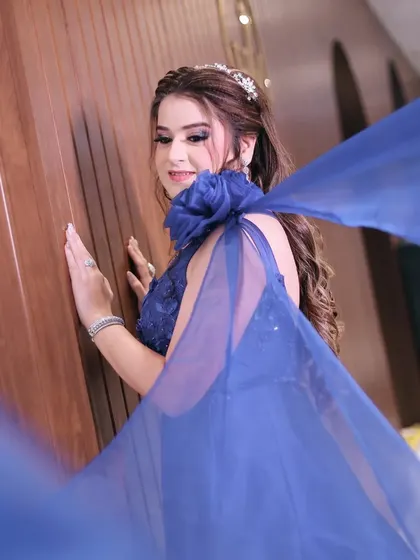 Another shot of the bride's flowing blue gown, capturing the elegance and drama of her outfit.