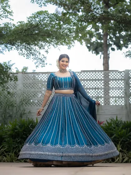 A full-length shot showcasing the entire look. The makeup is designed to be elegant and timeless.