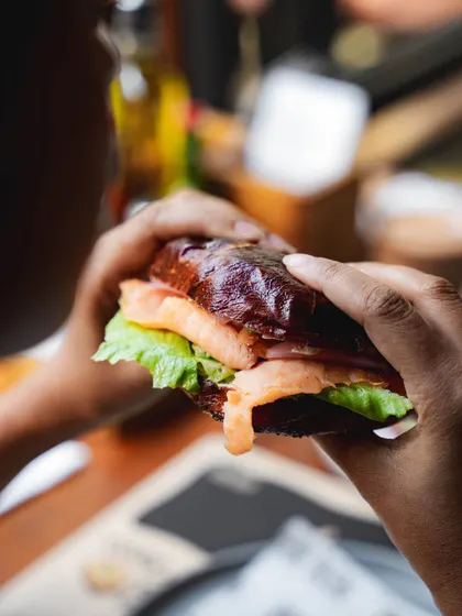 A close-up of our lye-dipped bagel sandwich, showing the glossy crust and fresh fillings.