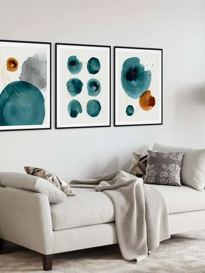 Add a splash of color with this abstract set of three watercolor prints. The interplay of teal and orange shapes creates a vibrant, modern look, perfect for brightening up a minimalist living room.