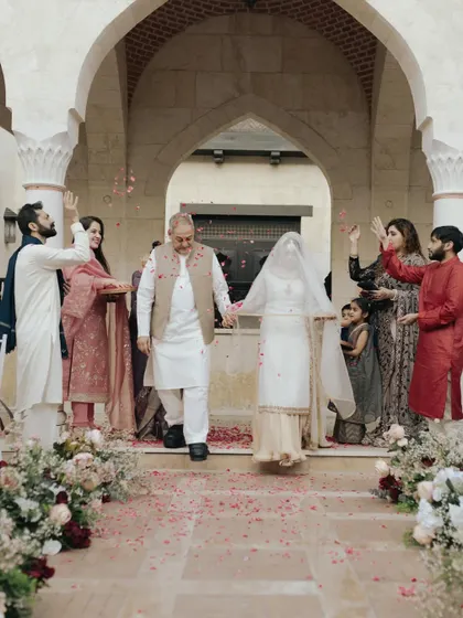 Moin and Roha's exit from their Nikah ceremony at the Ismaili Centre in Dubai, showered with petals by their loved ones. A moment of pure blessing and joy.