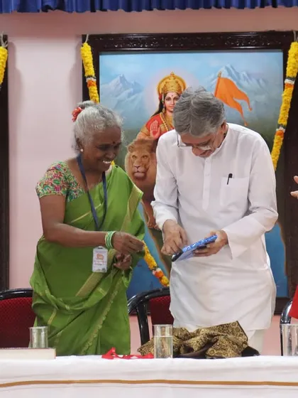 A moment of honor at the International Yoga Conference in Kanyakumari, with dignitaries on stage during the opening ceremony.