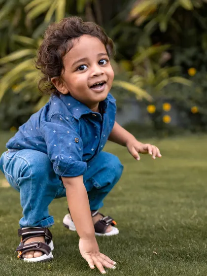 Look at that adventurous spirit. This little explorer was having the best time during our outdoor toddler photoshoot, crouching down in the grass with a curious and joyful expression. I love capturing the energy and personality of children as they discover the world around them.