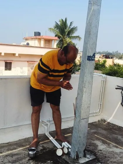 A customer performs a puja for the base of his new solar structure, welcoming positive energy to his solar investment.