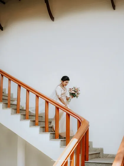 The bride, Navitha, gracefully descending the stairs. This elegant shot, with its clean lines and beautiful light, makes for a stunning bridal portrait.