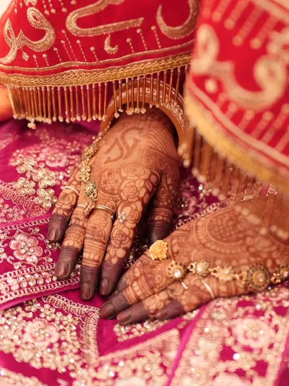 The final stain is so important, and I'm proud of the deep, dark color my organic henna produces. This is how beautifully the mehndi contrasts with a traditional red bridal lehenga, perfect for all your wedding photos.
