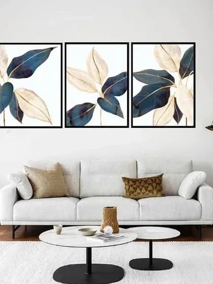 A beautiful set of three framed prints showcasing illustrative Aucuba leaves. The combination of deep blue and cream colors with delicate golden lines creates a sophisticated and elegant botanical display.