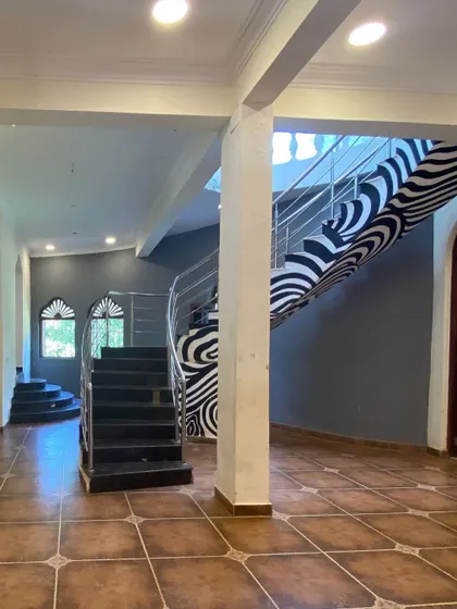 The original staircase in our Goan Holiday Villa project was dark and dominated by a bold, distracting pattern. It didn't fit the relaxed, earthy vibe we wanted to create.
