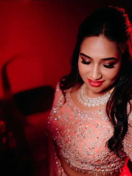 A close-up of the reception makeup. I created a soft smokey eye with a touch of shimmer and a classic red lip for a timelessly glamorous look.
