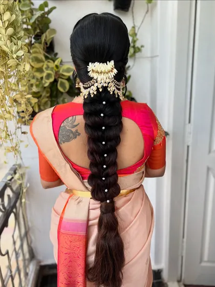 This angle showcases the beautiful drape of the pearl-studded braid. It's a perfect fusion of traditional structure and contemporary embellishment.