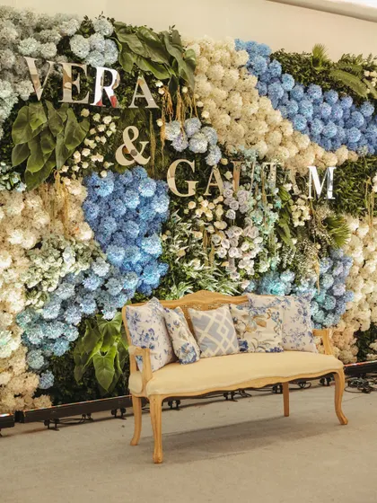 A living wall of flowers. For this elegant engagement, I designed a backdrop using thousands of hydrangeas in shades of blue and white, with the couple's initials emerging from the blooms. It’s a testament to my belief that even the grandest statements can be crafted with delicate, personal touches.