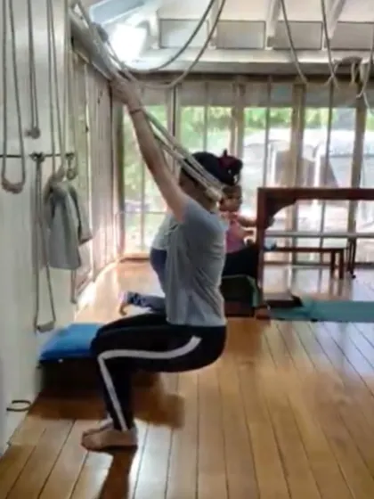 Using the wall ropes for support in this seated pose allows the student to lift and open the chest and shoulders. This is crucial for creating space for the lungs and heart, which is the foundation of good health and energy.