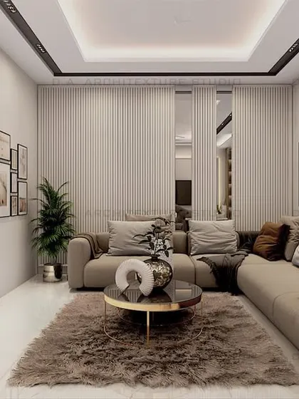 This cozy common area uses a plush rug and a comfortable L-shaped sofa to create a perfect spot for relaxation. The wall paneling and gallery wall add a personal touch.