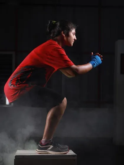 We build explosive athletes. This client is at the peak of a plyometric box jump, an exercise we use to develop power, agility, and coordination. This is functional fitness that translates to real world strength.