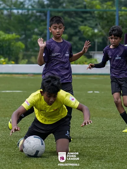 A tough slide tackle shows the competitive spirit of the Junior Fives League. I encourage players to be tenacious and fight for every ball while maintaining sportsmanship.