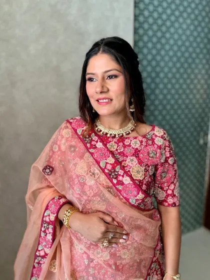 Dipped in glow. This floral pink lehenga is paired with soft, shimmery makeup for a beautiful daytime event.