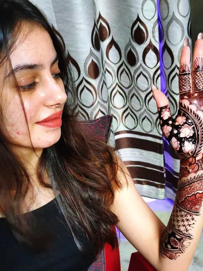 This is a full-arm mehndi design I did for a client. The pattern flows from the hand up the arm, combining bold floral elements with delicate shading.