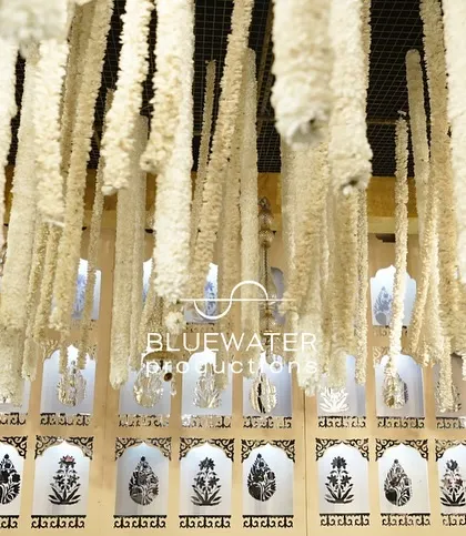 A close-up of the hanging floral strings and chandeliers that created the beautiful ceiling for the reception.