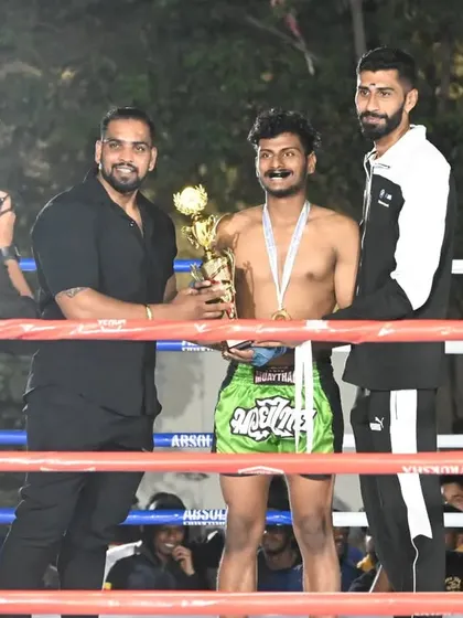Our champion, Sumin Pillai, receiving his trophy after winning the State Level Muay Thai Pro Championship.