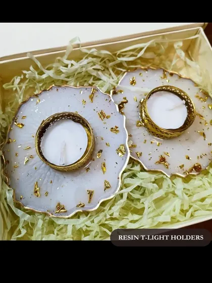 These elegant resin t-light holders with gold leaf accents are a beautiful option for corporate gifting, festival hampers, or employee appreciation. They are handcrafted to add a touch of warmth and light.