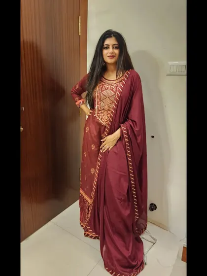 A deep maroon anarkali suit, elegant and regal. This is a wonderful choice for an evening reception or a formal dinner.