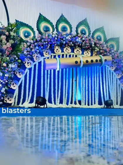 The Krishna naming ceremony stage with dramatic blue lighting, reflecting beautifully on the floor and enhancing the divine, serene atmosphere.