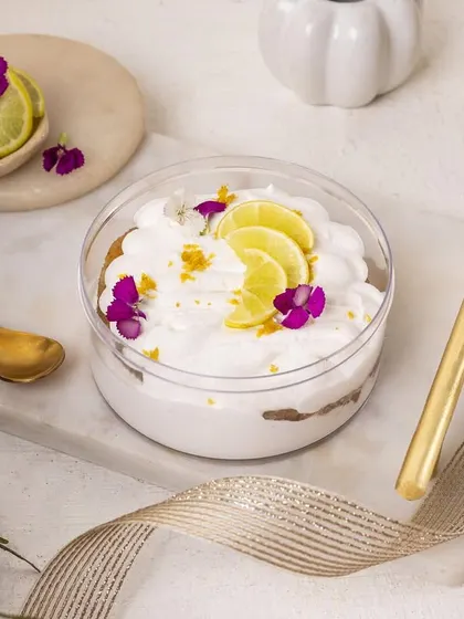 A zesty key lime pie tub dessert, decorated with fresh lime slices and edible flowers for a refreshing look.