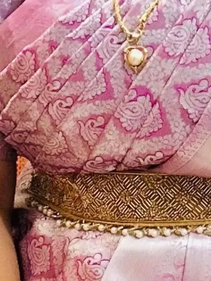 The perfectly pleated saree pallu and elegant waistband complete this party ensemble. Attention to detail is key for a polished finish.