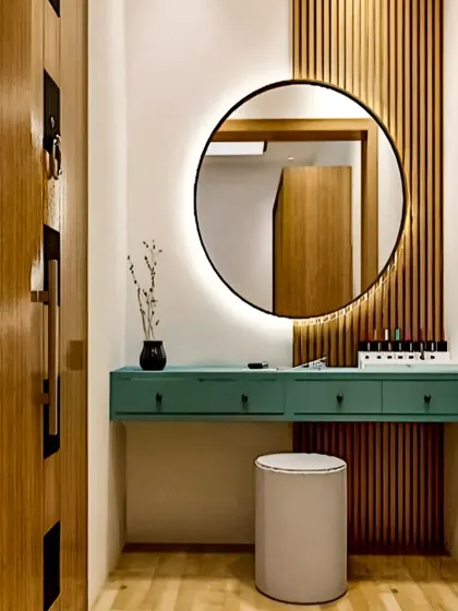 A chic floating dressing table with a backlit round mirror and fluted wood paneling, creating a perfect personal grooming corner.