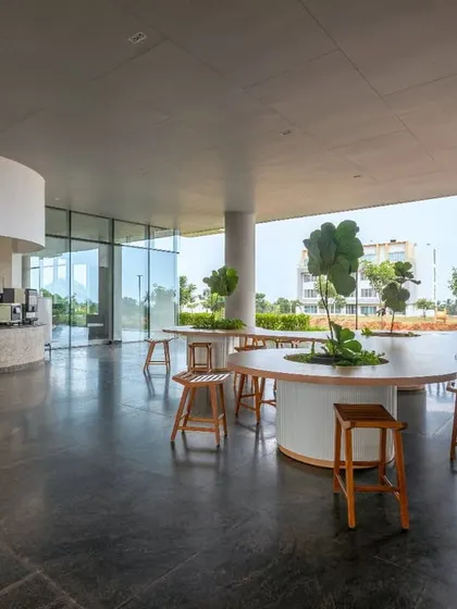 The cafeteria at the Pinnacle Campus, with its curved service counter and open-air design. This space is designed for community and connection, offering a refreshing break from the traditional office environment.