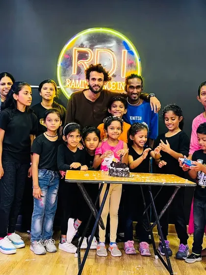 A group photo with students, instructors, and parents. Our studio is a community hub where everyone is welcome, and we cherish the support of our students' families.