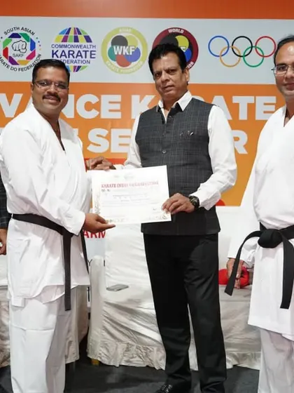 Presenting a certificate to a senior karateka at the Pune seminar. Continuous learning is key, and our advanced seminars are designed for coaches and experienced athletes to refine their skills.