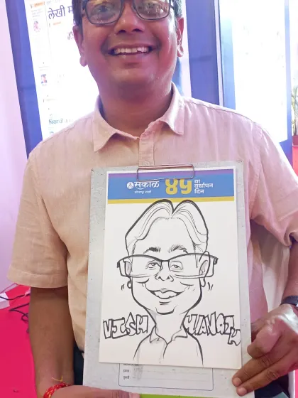 A guest proudly displaying his caricature at the Sakal Vardhapan Din event. I enjoy capturing the diverse faces of people who make an organization what it is.
