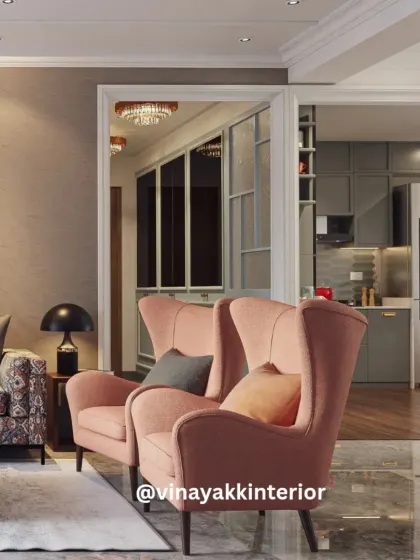 This view showcases how we connect different zones in an open-plan layout. The living area flows seamlessly into the kitchen and dining spaces, unified by a consistent color palette and elegant design choices like the blush wingback chairs.
