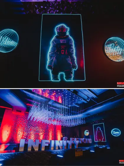 Neon signs featuring astronauts and custom logos lit up the venue. The large 'Infinity & Beyond' lettering and a stunning crystal chandelier added to the high-energy, futuristic vibe.
