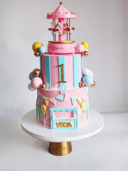 A rotating carousel cake is pure magic! This 3kg creation was for Veda's first birthday and featured a pink and blue carnival theme.