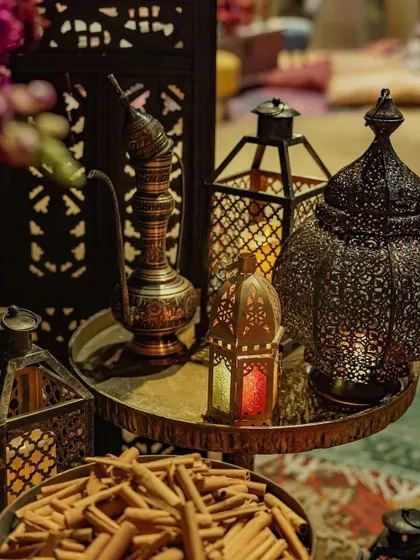 A collection of authentic Moroccan lanterns and a traditional teapot, used as decor elements to enhance the theme. These details are crucial for creating a truly believable and immersive experience.