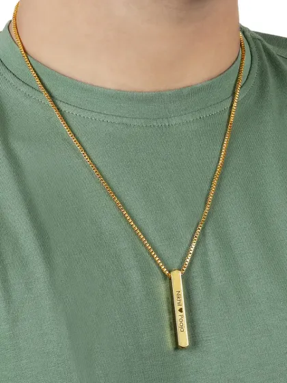 This shot shows the personalized bar necklace on a male model, demonstrating its unisex appeal. The casual green t-shirt makes the gold necklace stand out as a stylish everyday accessory.